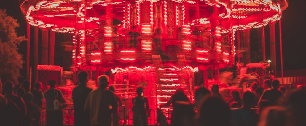 People looking at the red glowing carousel