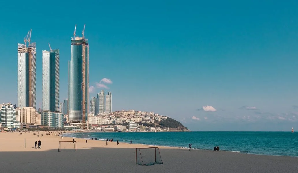 skyscrapers next to a beach in busan
